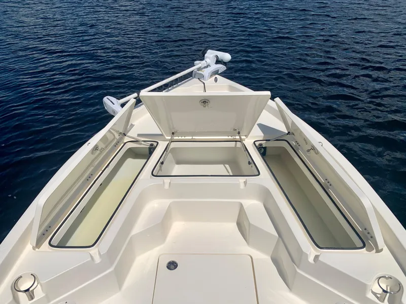 Slide: The Image of 2016 Skeeter SX230 boat with open storage compartments on the water. - 22