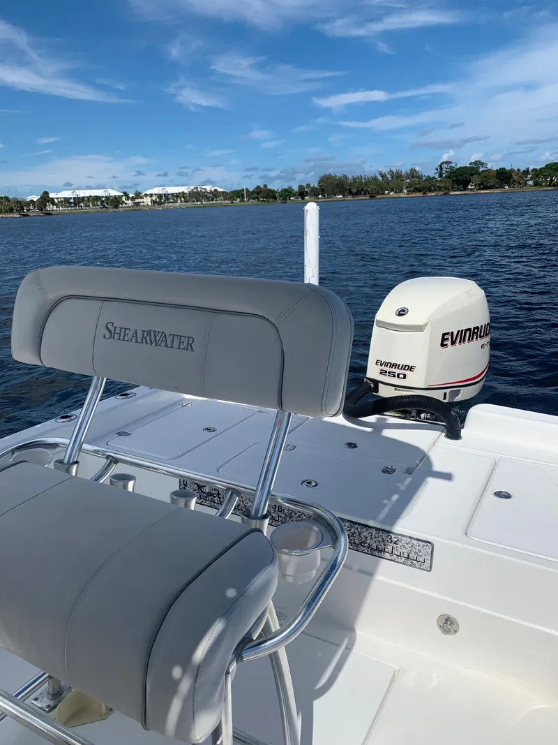 Slide: The Image of 2005 ShearWater z2400 boat with Evinrude engine on a sunny day. - 17