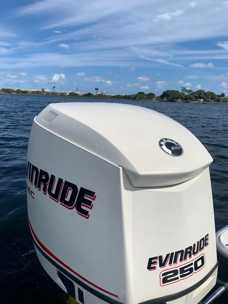 Slide: The Image of Evinrude 250 outboard motor on a 2005 ShearWater z2400 boat, on a sunny day. - 18