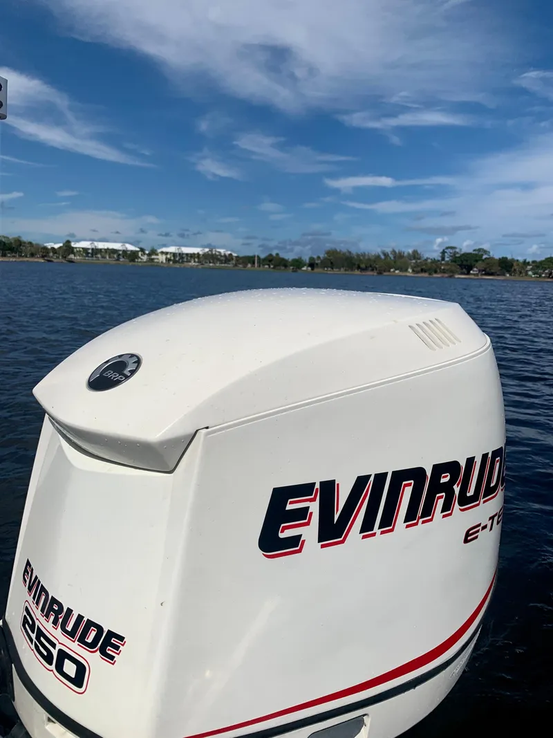 Slide: The Image of Evinrude 250 outboard motor on a 2005 ShearWater z2400 boat, lake background. - 19