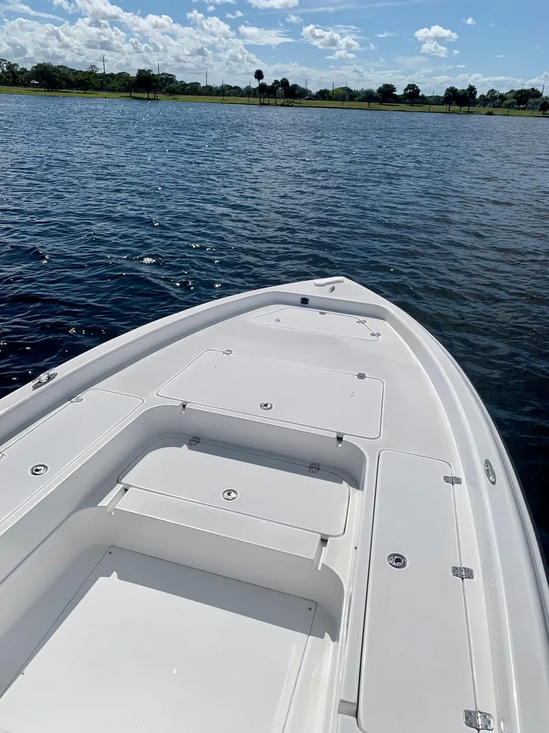 Slide: The Image of Bow of a 2005 ShearWater z2400 boat on a calm lake. - 20