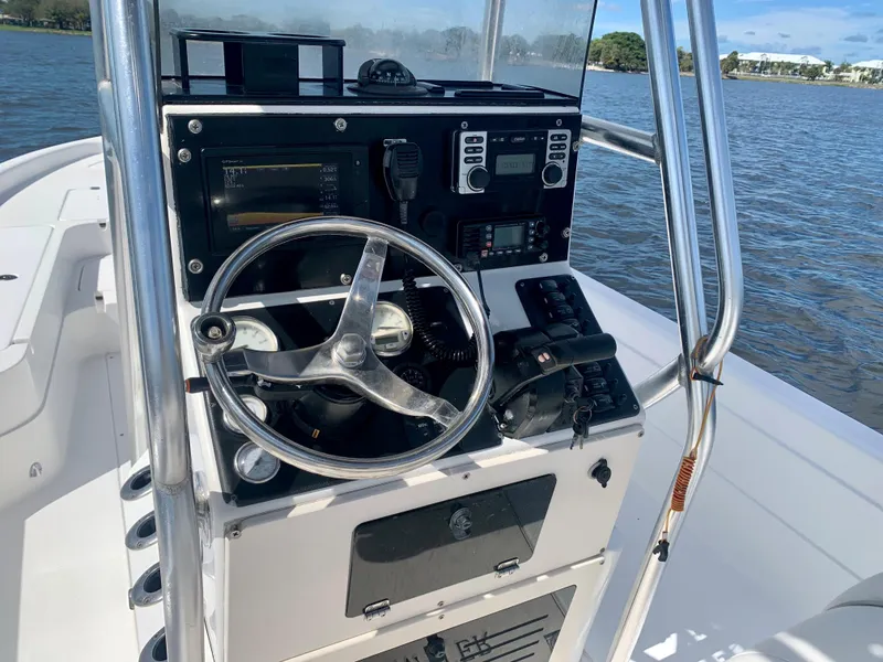 Slide: The Image of 2005 ShearWater z2400 boat console with steering wheel and navigation equipment. - 22