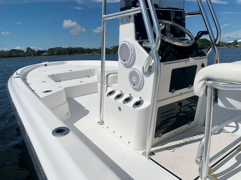 Slide: The Image of 2005 ShearWater z2400 boat interior with steering console and seating. - 23