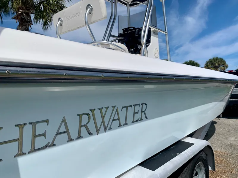 Slide: The Image of 2005 ShearWater z2400 boat on trailer under blue sky. - 7