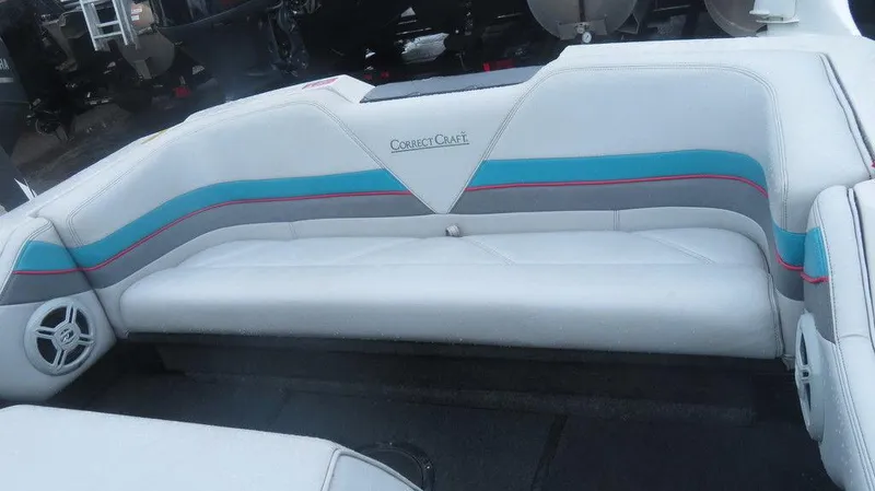 Slide: The Image of 1990 Nautique Ski boat interior with white and teal seating. - 10