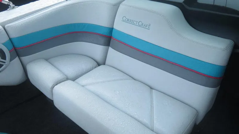 Slide: The Image of 1990 Nautique Ski boat interior with white, blue, and gray upholstery. - 2