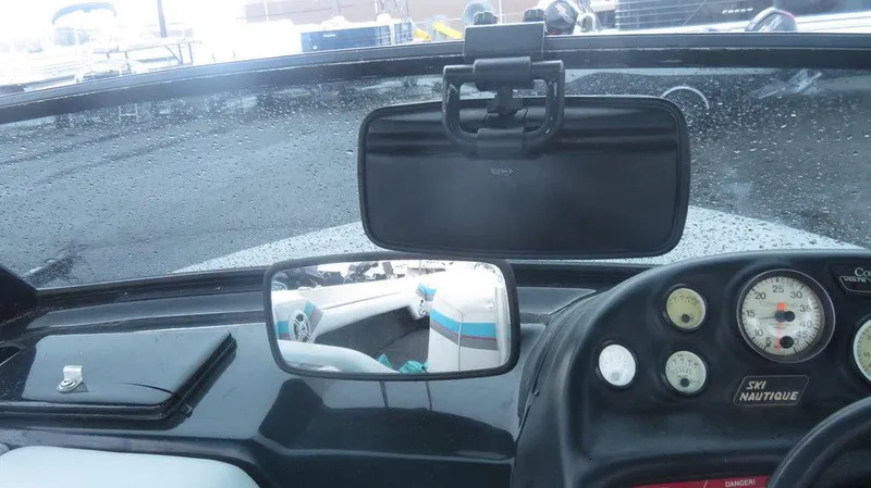 Slide: The Image of 1990 Nautique Ski boat dashboard with gauges and rearview mirrors. - 4