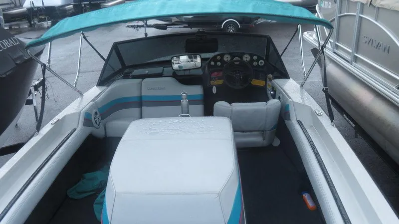 Slide: The Image of 1990 Nautique Ski boat interior with teal canopy and white seating. - 6