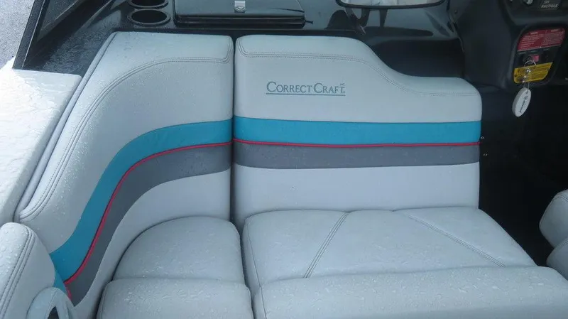Slide: The Image of 1990 Nautique Ski boat interior with Correct Craft logo and colorful upholstery. - 7