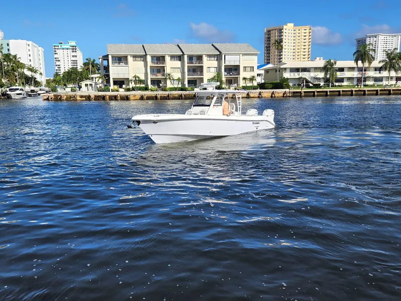 Slide: The Image of 2019 Everglades 365 boat cruising on a sunny day near waterfront buildings. - 10