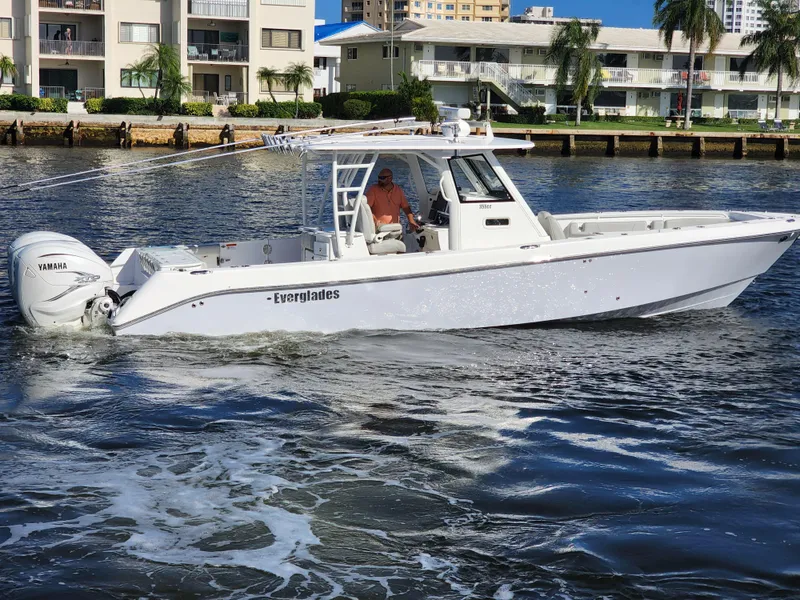 Slide: The Image of 2019 Everglades 365 boat cruising on water near waterfront buildings. - 12