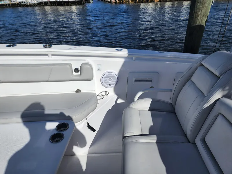 Slide: The Image of 2019 Everglades 365 boat interior with gray seating and cup holders. - 17