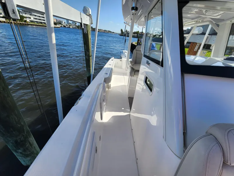 Slide: The Image of 2019 Everglades 365 boat docked by the water on a sunny day. - 22