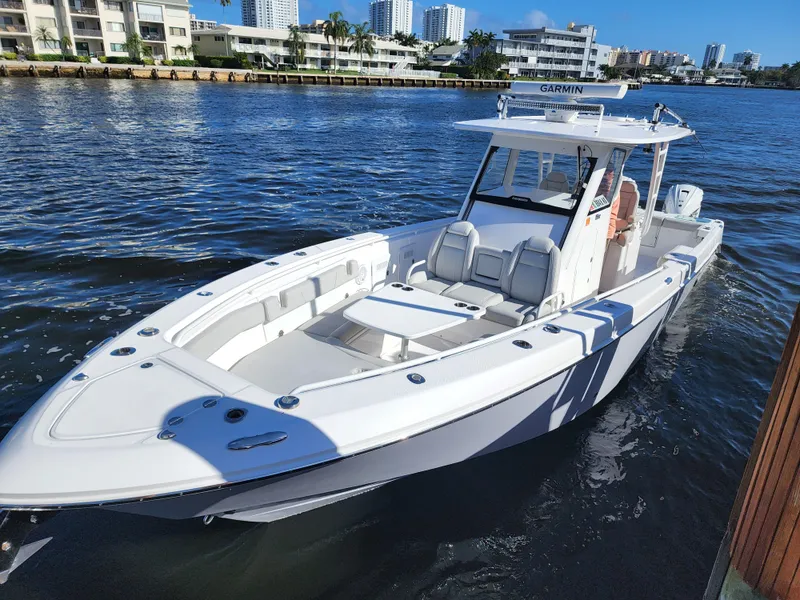 Slide: The Image of 2019 Everglades 365 boat docked in a marina with waterfront buildings. - 23