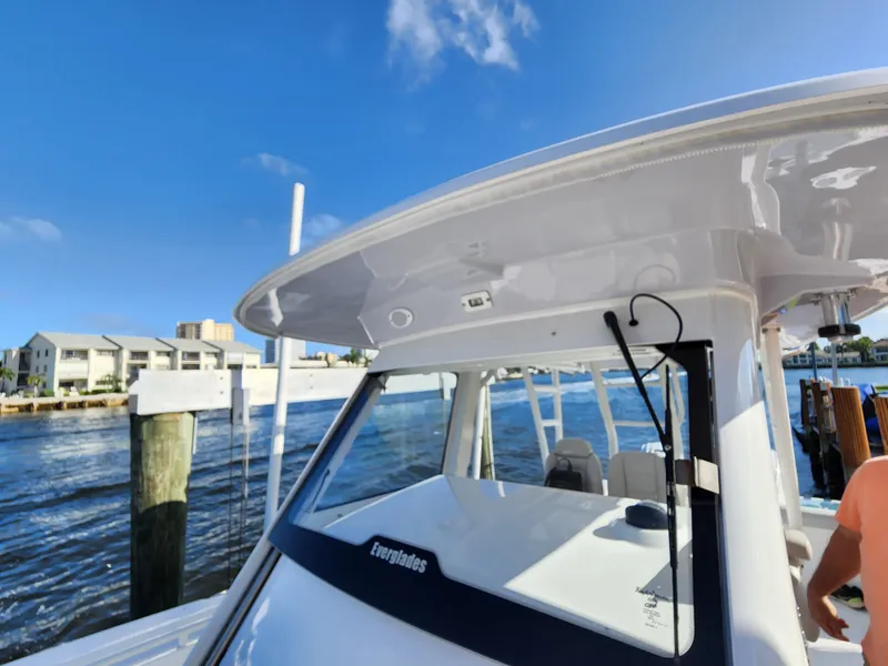 Slide: The Image of 2019 Everglades 365 boat docked by waterfront homes on a sunny day. - 25