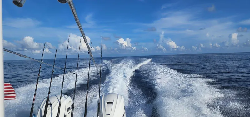 Slide: The Image of Boat wake on open sea, Everglades 365, 2019 model, with fishing rods and engines visible. - 29