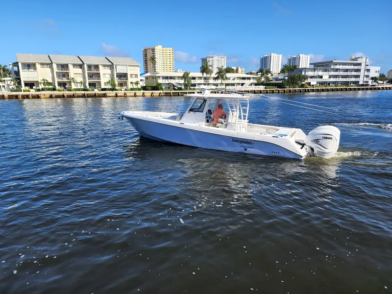Slide: The Image of 2019 Everglades 365 boat cruising on a sunny day near waterfront buildings. - 3