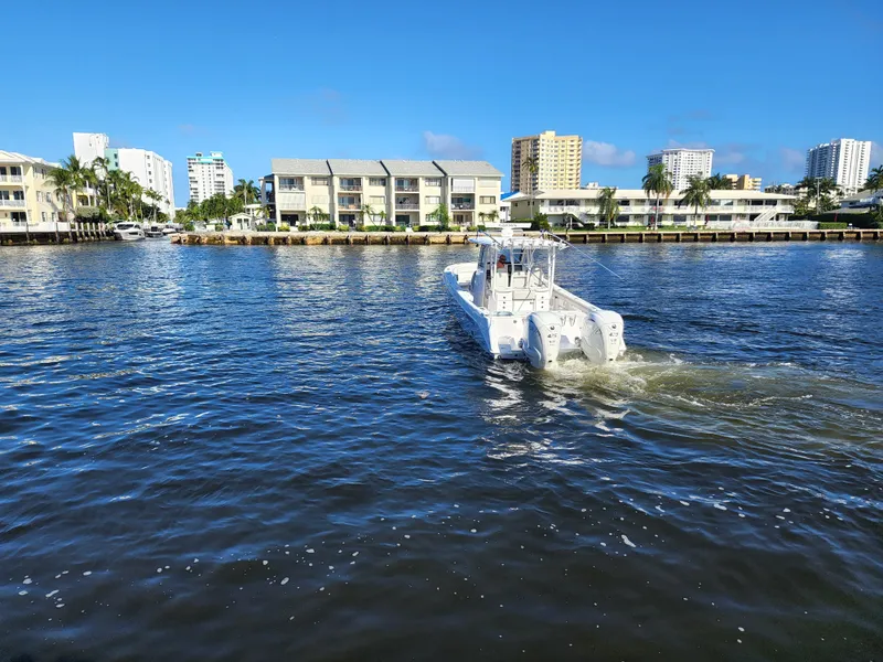Slide: The Image of 2019 Everglades 365 boat cruising on a sunny day near waterfront buildings. - 4