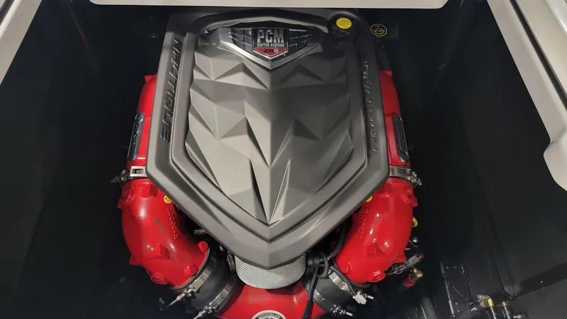 Slide: The Image of 2022 Nautique Super Air Nautique S23 engine with red components and PCM cover. - 12