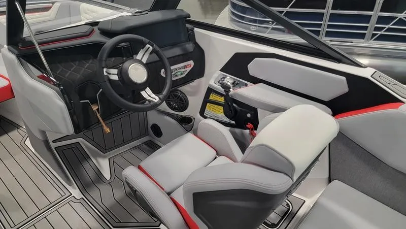 Slide: The Image of 2022 Nautique Super Air Nautique S23 interior with modern helm and seating. - 7