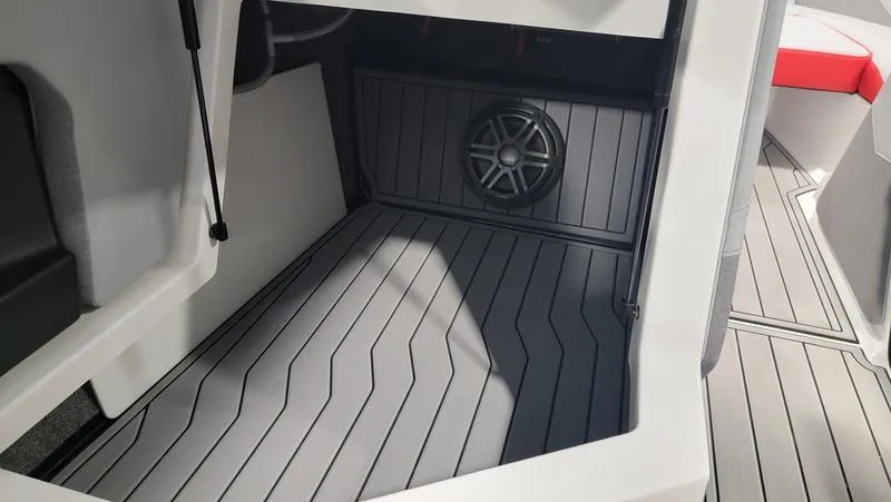 Slide: The Image of 2022 Nautique Super Air Nautique S23 interior with speaker and sleek flooring design. - 9