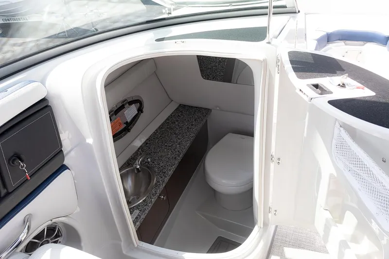 Slide: The Image of 2022 Crownline E 255 XS boat interior bathroom with sink and toilet. - 18