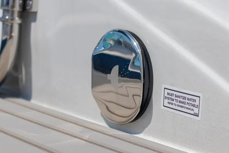 Slide: The Image of Close-up of 2022 Crownline E 255 XS boat's water system sanitization notice. - 22