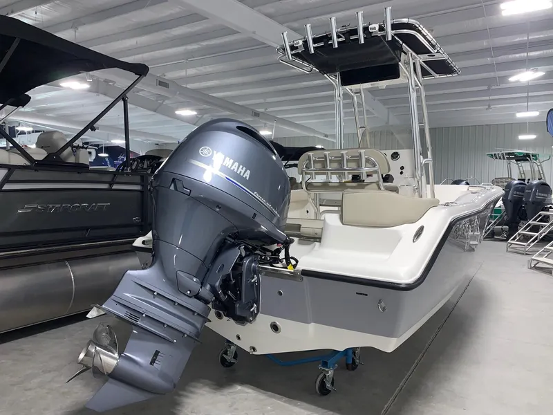 Slide: The Image of 2024 Key West 203 FS boat with Yamaha outboard motor in showroom. - 1