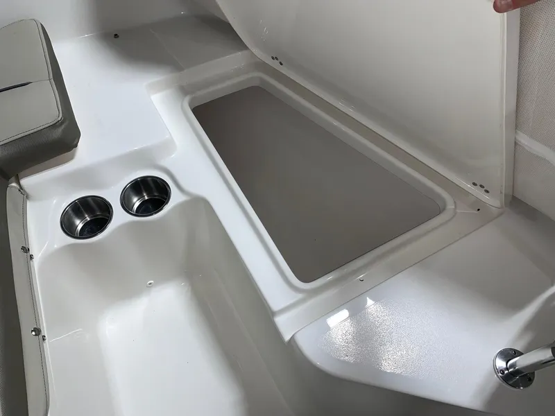 Slide: The Image of 2024 Key West 203 FS boat interior with storage compartment and cup holders. - 12