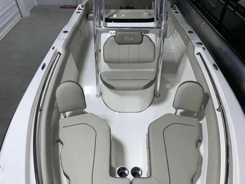 Slide: The Image of 2024 Key West 203 FS boat interior with beige seating and stainless steel fixtures. - 13