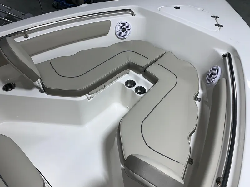 Slide: The Image of 2024 Key West 203 FS boat with cushioned seating and built-in cup holders. - 14