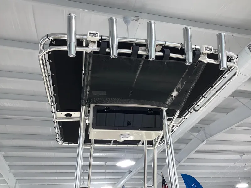 Slide: The Image of 2024 Key West 203 FS boat T-top with rod holders in a showroom. - 3