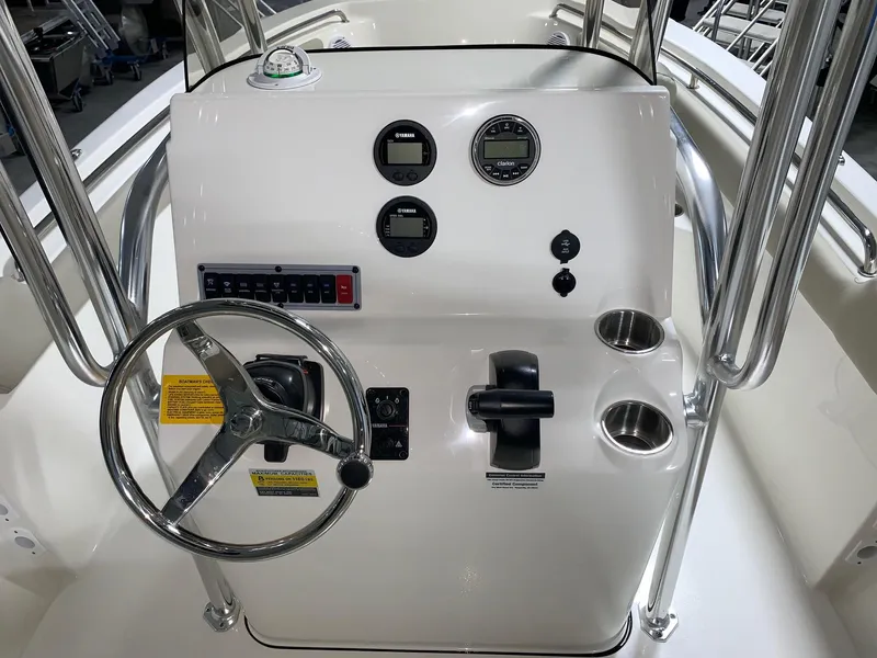 Slide: The Image of 2024 Key West 203 FS boat console with steering wheel, gauges, and controls. - 8