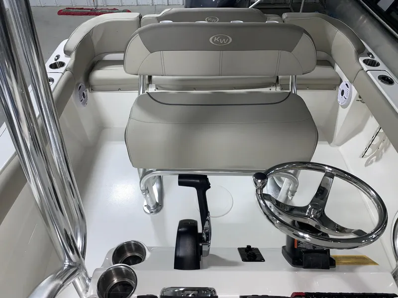 Slide: The Image of 2024 Key West 203 FS boat interior with steering wheel and seating. - 9