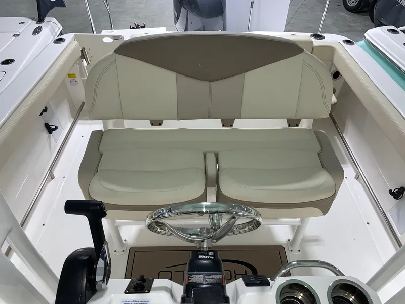 Slide: The Image of 2024 Robalo R222 Explorer boat interior with dual seats and steering wheel. - 9