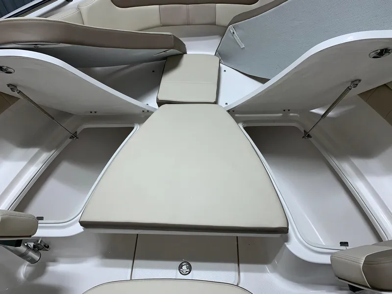 Slide: The Image of 2024 Robalo R222 Explorer boat interior with beige cushioned seating. - 10
