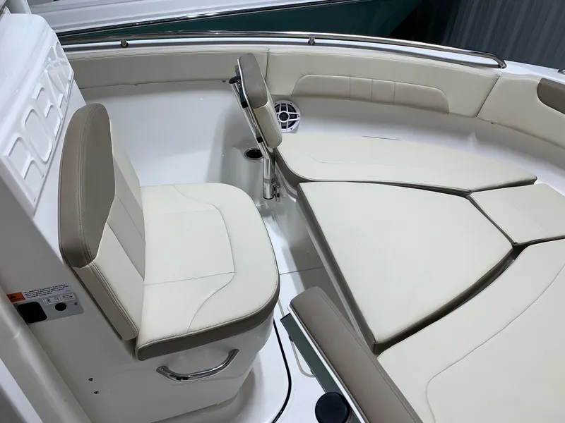Slide: The Image of 2024 Robalo R222 Explorer boat interior with cushioned seating and stainless steel railings. - 11