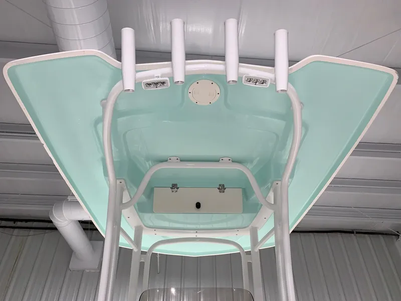 Slide: The Image of 2024 Robalo R222 Explorer boat top view in a storage facility. - 4