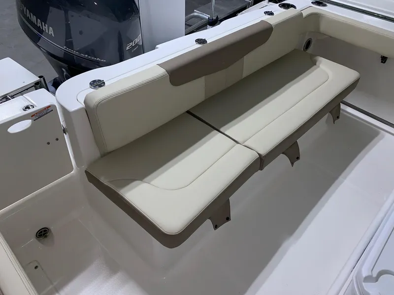 Slide: The Image of 2024 Robalo R222 Explorer boat with beige cushioned seating and Yamaha 200 engine. - 5