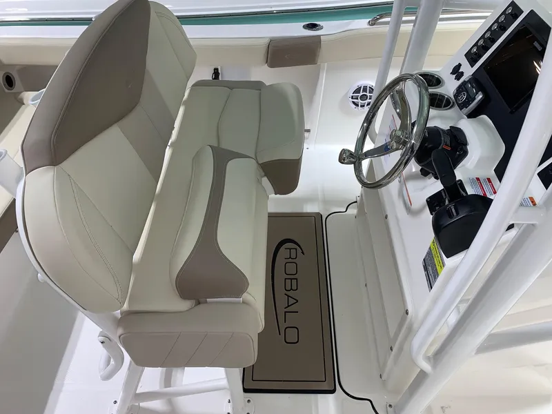 Slide: The Image of 2024 Robalo R222 Explorer boat cockpit with dual seats and steering console. - 8