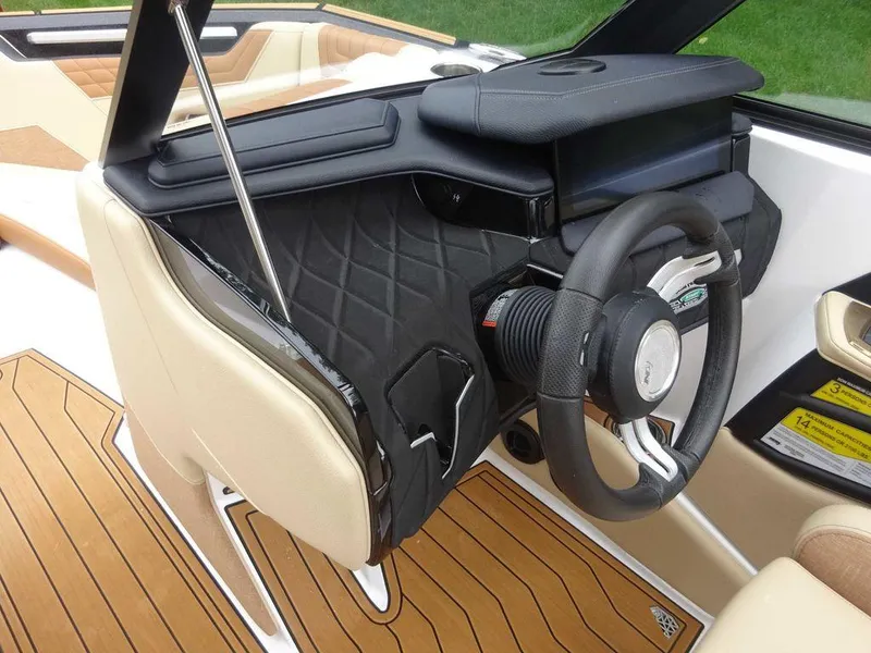 Slide: The Image of 2023 Nautique S21 boat interior, featuring a modern steering wheel and dashboard. - 12