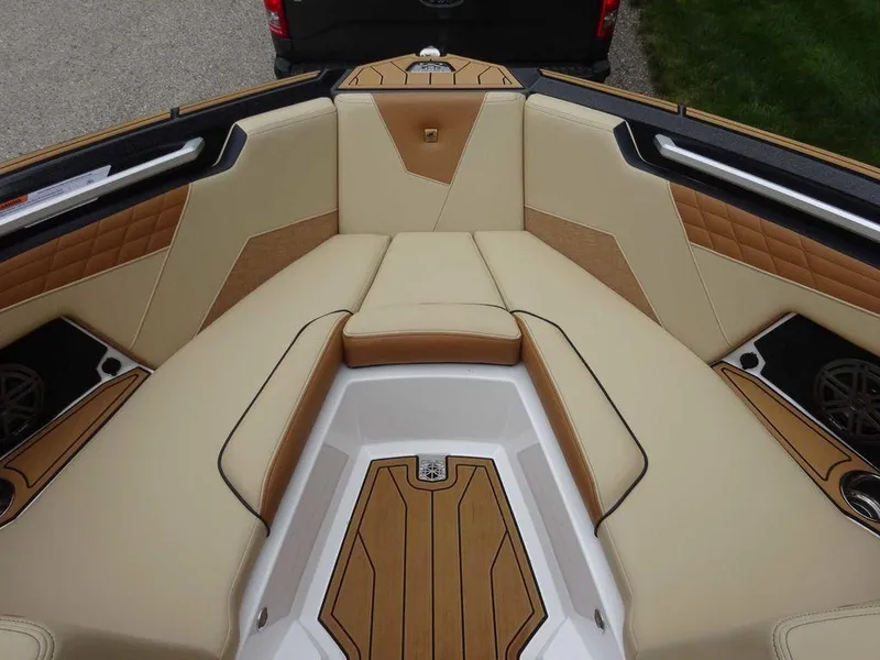 Slide: The Image of 2023 Nautique S21 boat interior with tan and brown upholstery. - 17