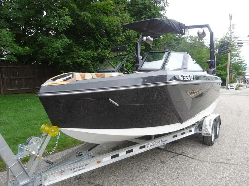 Slide: The Image of 2023 Nautique S21 boat on a trailer, parked on a street. - 5