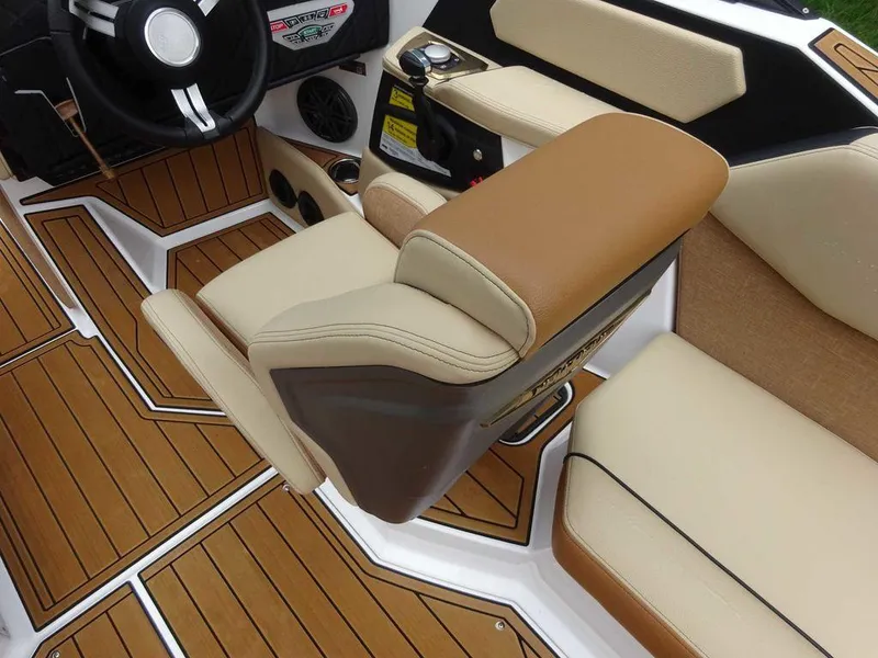 Slide: The Image of 2023 Nautique S21 boat interior with tan and brown seating and teak flooring. - 8