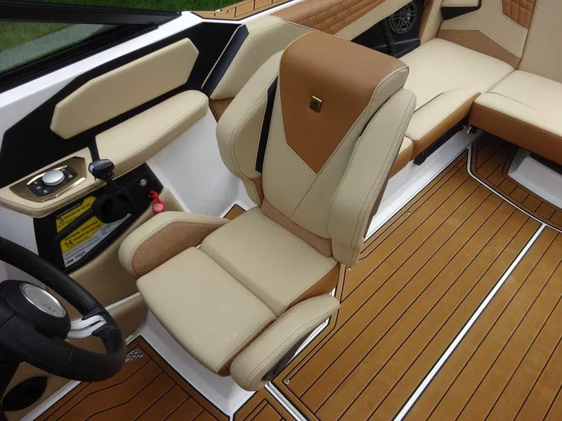 Slide: The Image of 2023 Nautique S21 boat interior with tan and beige seating and teak flooring. - 9