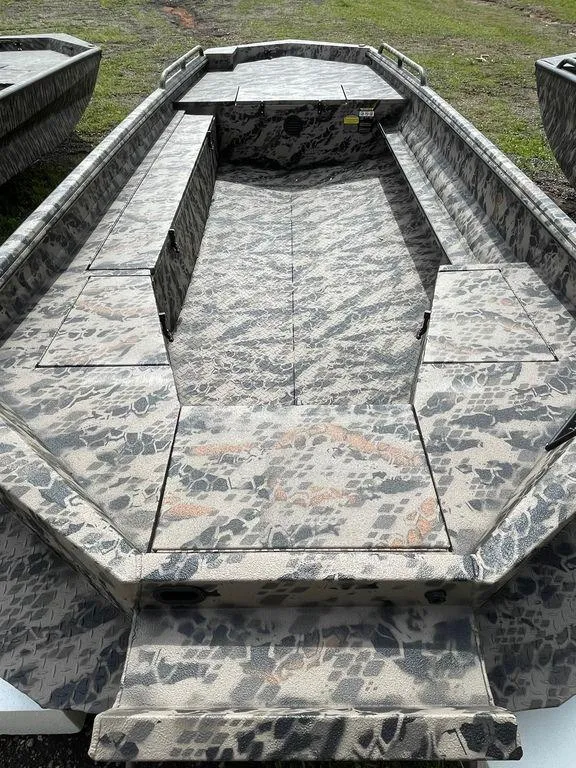 Slide: The Image of 2022 Havoc 1860 Dbst boat with camouflage interior, parked on grass. - 3