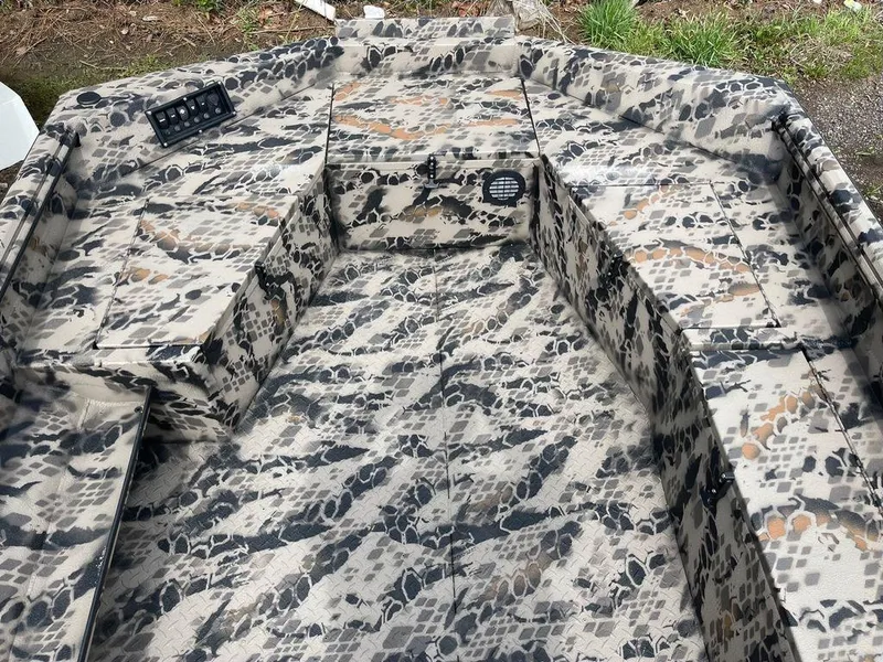 Slide: The Image of 2022 Havoc 1860 Dbst boat interior with camouflage pattern and control panel. - 6