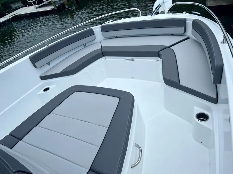 Slide: The Image of 2024 Jeanneau Leader 9.0 CC boat interior with gray cushioned seating. - 12