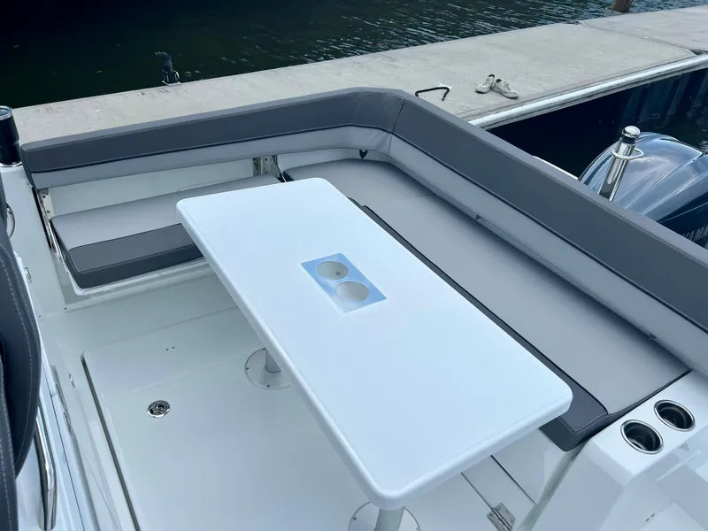 Slide: The Image of 2024 Jeanneau Leader 9.0 CC boat with seating and table on deck. - 14