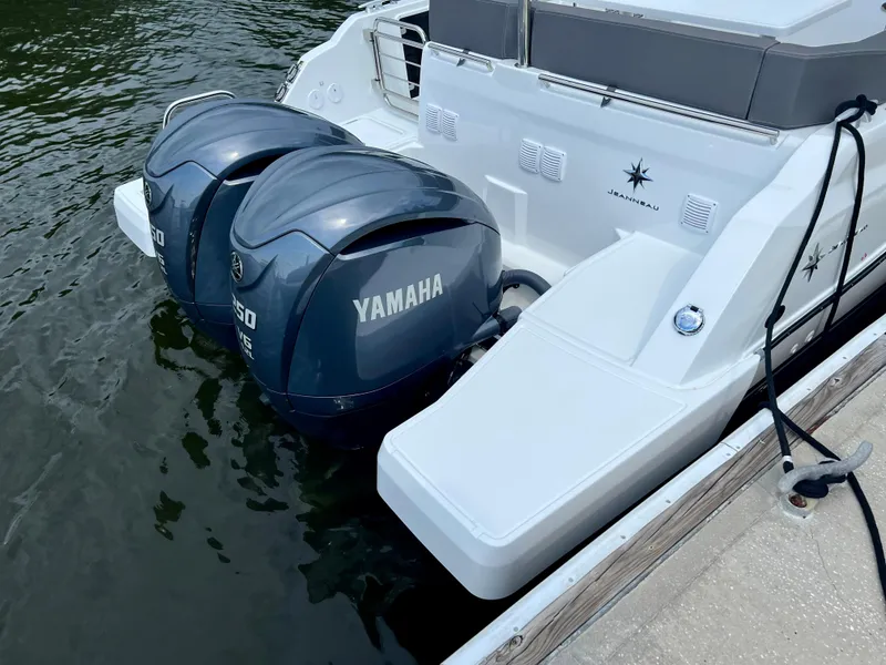 Slide: The Image of 2024 Jeanneau Leader 9.0 CC with twin Yamaha outboard engines docked. - 18